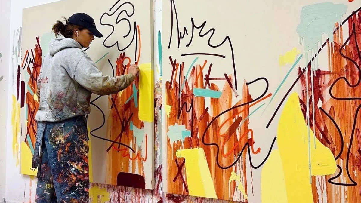 Olivia Longstaff painting her Precipice artwork